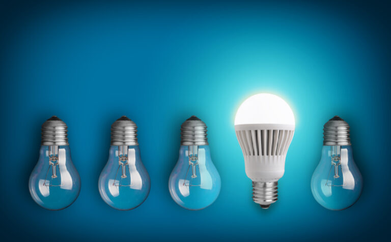 Idea concept with row of light bulbs and glowing LED bulb